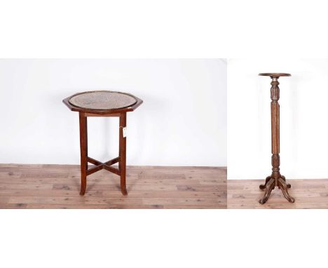A decorative carved walnut jardinière stand, c.1900 with circular moulded top above a reeded and leaf carved stem, raised on 