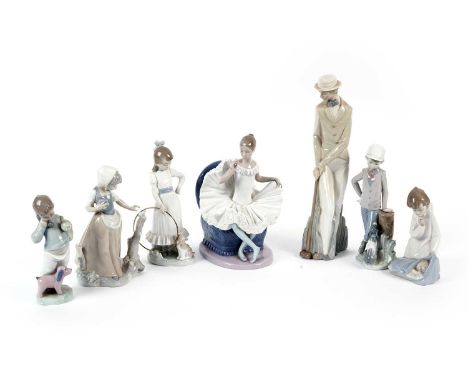 A selection of Lladro and Nao figures, some with their boxes, including: a ballerina seated on an armchair; an angel with a c