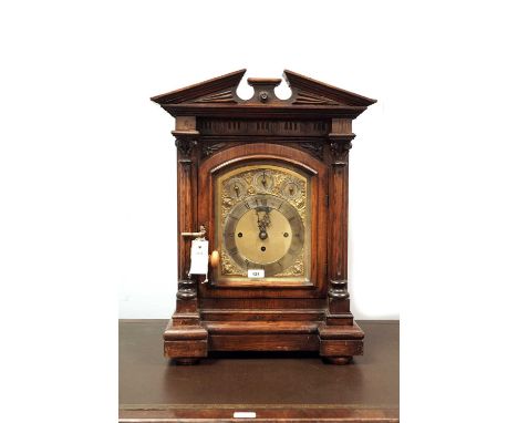 A late 19th Century carved oak bracket clock, with silvered roman dial and subsiduary chime/silent, slow/fast and chime on 8 