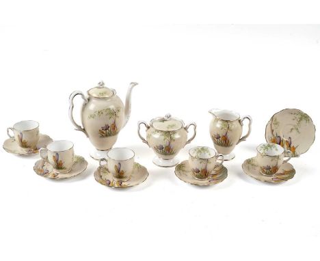 A Royal Albert ‘Crocus’ pattern part tea service, comprising: a tea pot, a cream jug, a sugar bowl, five teacups, and six sau