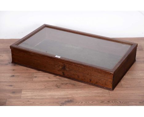A stained pine table top display cabinet, with hinged glazed panel top, opening to reveal a felt lined interior, 20th Century