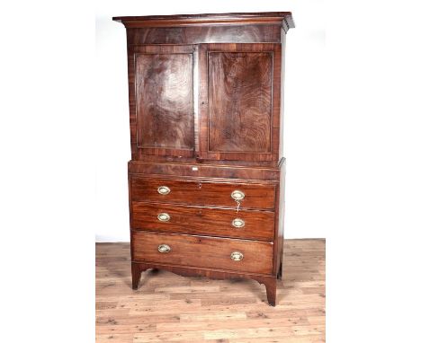 A 19th Century mahogany linen press, the top fitted with two panel cupboard doors, opening to reveal two shelves, above three