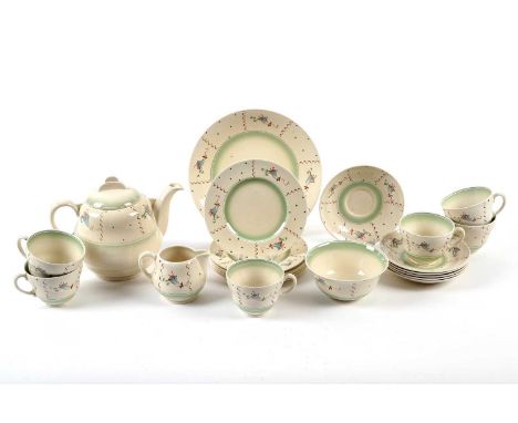 A Clarice Cliff tea service, decorated with stylised flowers in blue and pink, with brown swirly lines, on a cream ground, gr