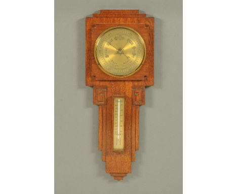 An Art Deco period oak wall mounted barometer.  Height 59.5 cm. 