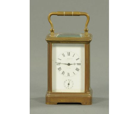 An Edwardian brass cased alarm carriage clock, height excluding carrying handle 10 cm. CONDITION REPORT: The movement does wi