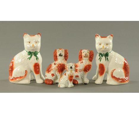 Three orange patch Staffordshire dogs, 19th century, and a pair of Staffordshire orange patch cats, 20th century.  Tallest 19