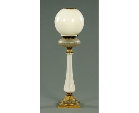 A Victorian opalescent glass table lamp, with clear and frosted glass reservoir above an opalescent stem in turn on a gilt me