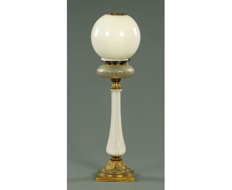 A Victorian opalescent glass table lamp, with clear and frosted glass reservoir above an opalescent stem in turn on a gilt me