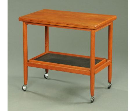 A Danish teak turnover top trolley, circa 1970's, the rectangular top upon circular legs with removable under tray on chromiu