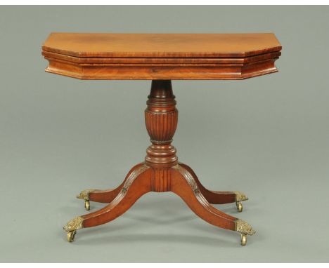 A Regency mahogany turnover top card table, possibly American, the top with canted angles and with downswept legs terminating