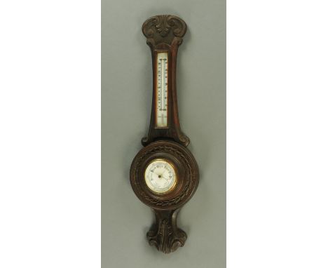 An early 20th century oak cased aneroid barometer, height 84 cm.