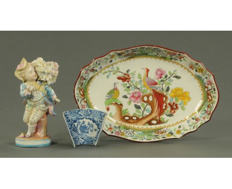 An English blue and white transfer printed asparagus dish, a Continental porcelain figure of a young boy and a Copeland Spode