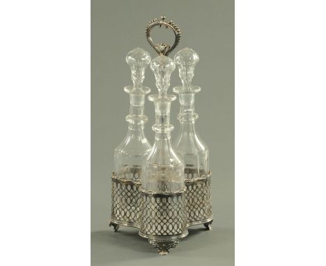 A silver plated three bottle decanter stand, 19th century, with three matching decanters with hollow stoppers, single ring to