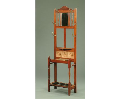 An Edwardian walnut hall stand, with mirror, tiles and shelf.  Width 55 cm. 