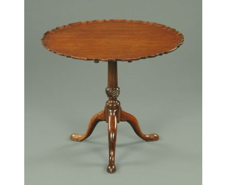 A George III mahogany tripod table, with piecrust edge, snap action, turned column and raised on three downswept legs termina