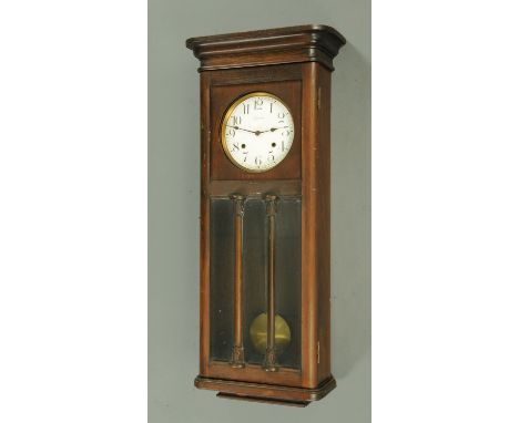 An Ansonia wall clock, large form, with two-train striking movement and with moulded cornice.  Height 90 cm. CONDITION REPORT