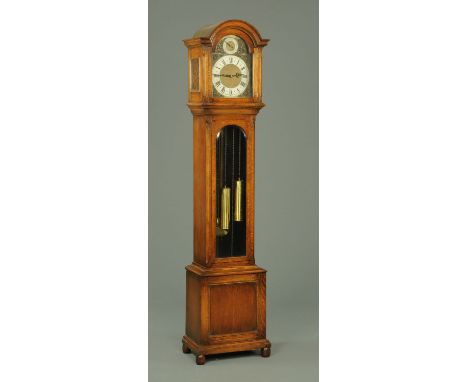 An oak longcase clock, circa 1930, with St. Michael Westminster or Whittington chimes, the trunk door glazed.  Height 200 cm.