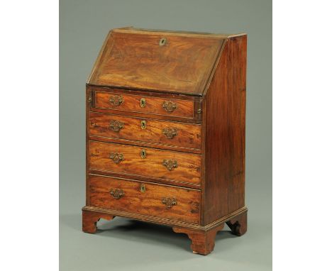 A Georgian mahogany bureau, with slope front above four long drawers with brass drop handles and raised on bracket feet, alte