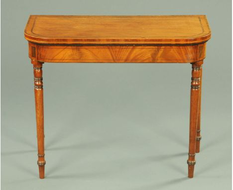 A Regency mahogany rosewood banded turnover top card table, with rounded corners, boxwood and ebony strung frieze and raised 