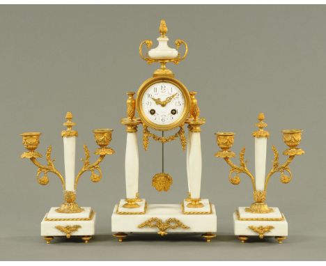 A French Carrara marble gilt metal mounted clock garniture, the clock with vase finial and enamelled dial signed "Masson Troy