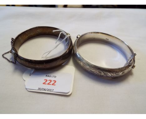 Two vintage silver hinged bangles with chased floral engraved decoration  some denting to bangle in need of a clean and surfa