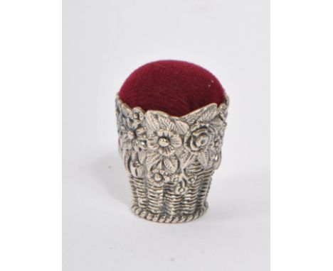 A 20th Century vintage .925 sterling silver pin cushion in the form of a floral basket having dark red cushion material. Meas