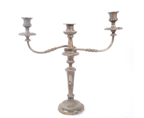 An early 20th Century large silver plated twisted twin arm candelabra having scalloped edge detailing to sconce and drip pan,