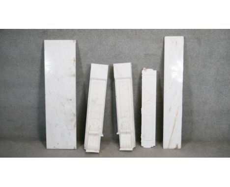 A marble fire surround with moulded mantel shelf above frieze panel and Classical style scrolling pilasters with large hearth