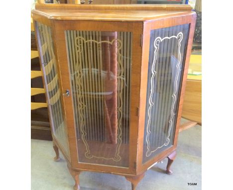 A vintage small shaped glass shelf display case