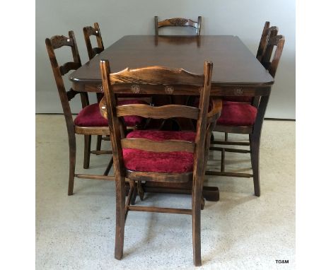 A mahogany extending table with 6 chairs to include carvers with ladder backs