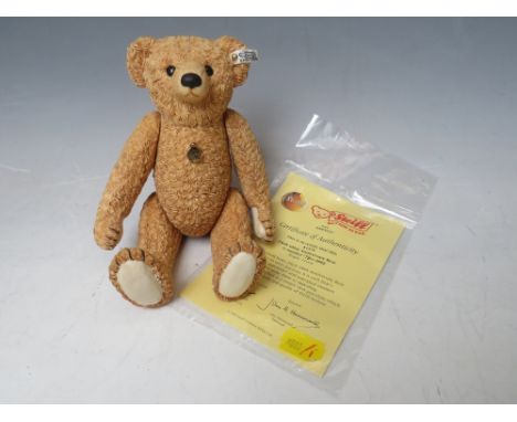 A CERAMIC 100th ANNIVERSARY LIMITED EDITION STEIFF BEAR, with certificate, having jointed limbs H 18.5 cm