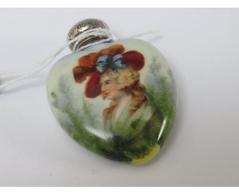 A HEART SHAPED PORCELAIN SCENT BOTTLE, with portrait of a lady and hallmarked silver top, 5.5 cm