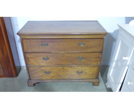 A Georgian mahogany chest of three graduated drawers with brass drop handles on bracket feet - 87cm x 100cm x 55cm - needing 