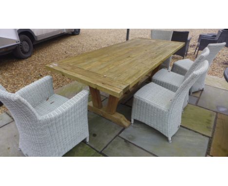 A Bramblecrest Kuta teak garden table 240cm long with a bench and five chairs