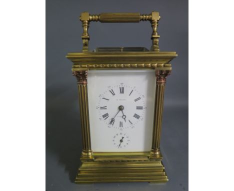A brass cased French carriage clock with alarm and repeat, signed H Kreitz with subsidiary second dial below - Height 20cm wi