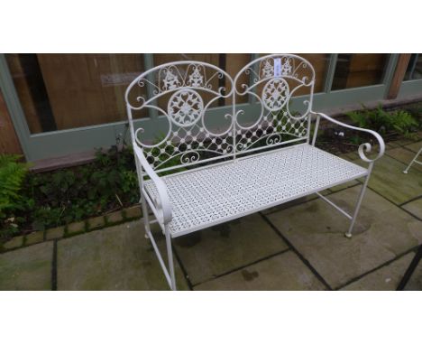 A wrought iron folding garden bench