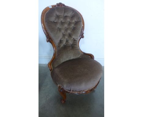 A Victorian walnut button back nursing chair 