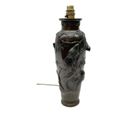 20th century Japanese bronzed table lamp of of tapered cylindrical form, decorated in relief with birds upon blossoming branc