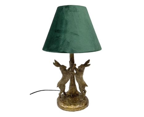 Composite table lamp, modelled as a pair of boxing hares, with a green velvet shade, H45cmDimensions: Height:&nbsp;48cm&nbsp;