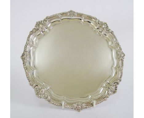 A late Victorian hallmarked sterling silver salver by George Howson, London 1900, with pie crust border cast with shells, rai