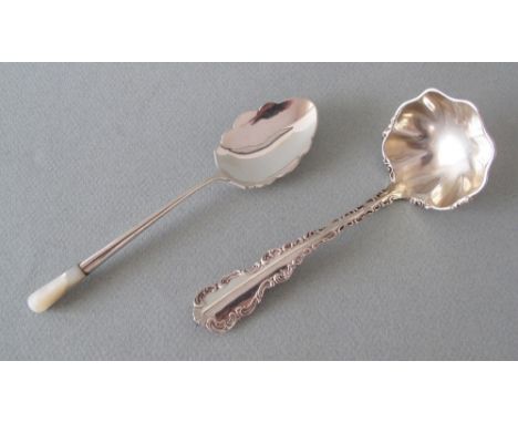 A hallmarked sterling silver sauce ladle with wavy rim and a hallmarked sterling silver serving spoon with mother of pearl ed