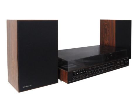 A music center (1970-80) by National Panasonic with an acrylic cover and two speakers veneered in rosewood. The main centre c