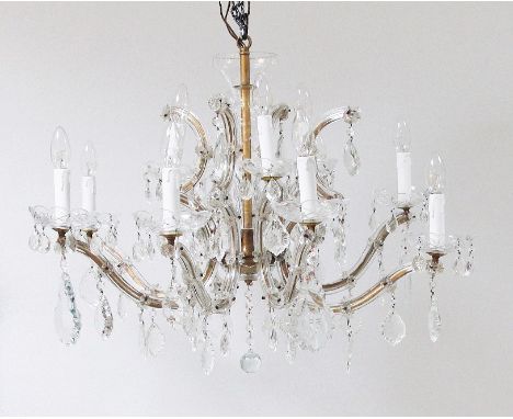 A continental, Venician style 12 light two tier crystal chandelier, c1930, with gilt metal arms covered with crystal. The arm