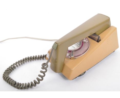 A retro vintage mid 20th century circa 1960s bakelite cased dial trimphone telephone in beige brown colourways. Serial number