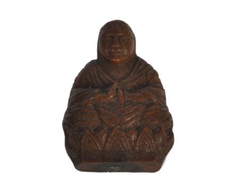 A 19th Century Chinese carved wood figurine depicting Buddha. The figure modelled in a seated position with hands closed rais