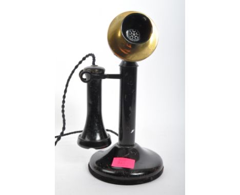 An early 20th century metal American pre dial candlestick telephone with brass detailing to microphone. It measures approx. 3