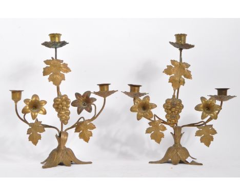 A pair of 19th century French gilt candelabra candlestick being decorated with fruit and florals upon a naturalistic base. Me