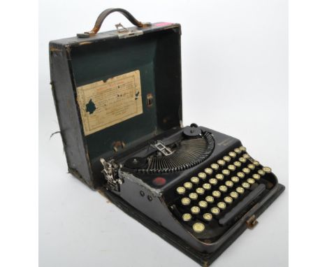 An early 20th century circa 1920s Remington Portable typewriter, model No. NM43019 in black leather case. Case measuring appr