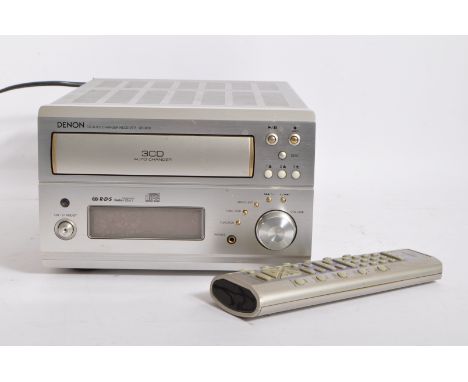 A Denon UD-M50 3CD changer micro Hi-Fi receiver with FM/AM Radio and an AUX input amplifier. Silver in colour and complete wi