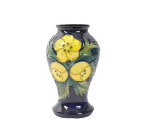 A vintage 20th Century Moorcroft pottery ceramic buttercup vase. Having a lipped top with tapering circular body on a round b